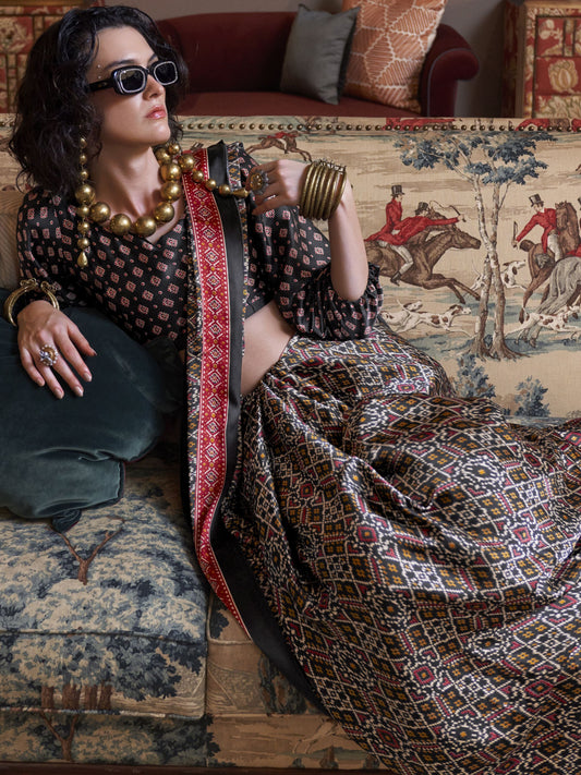 Black color satin crepe patola printed saree for wedding 
