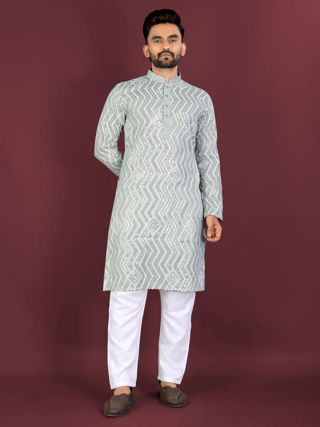 Man wearing a light gray kurta with white patterns on a maroon background