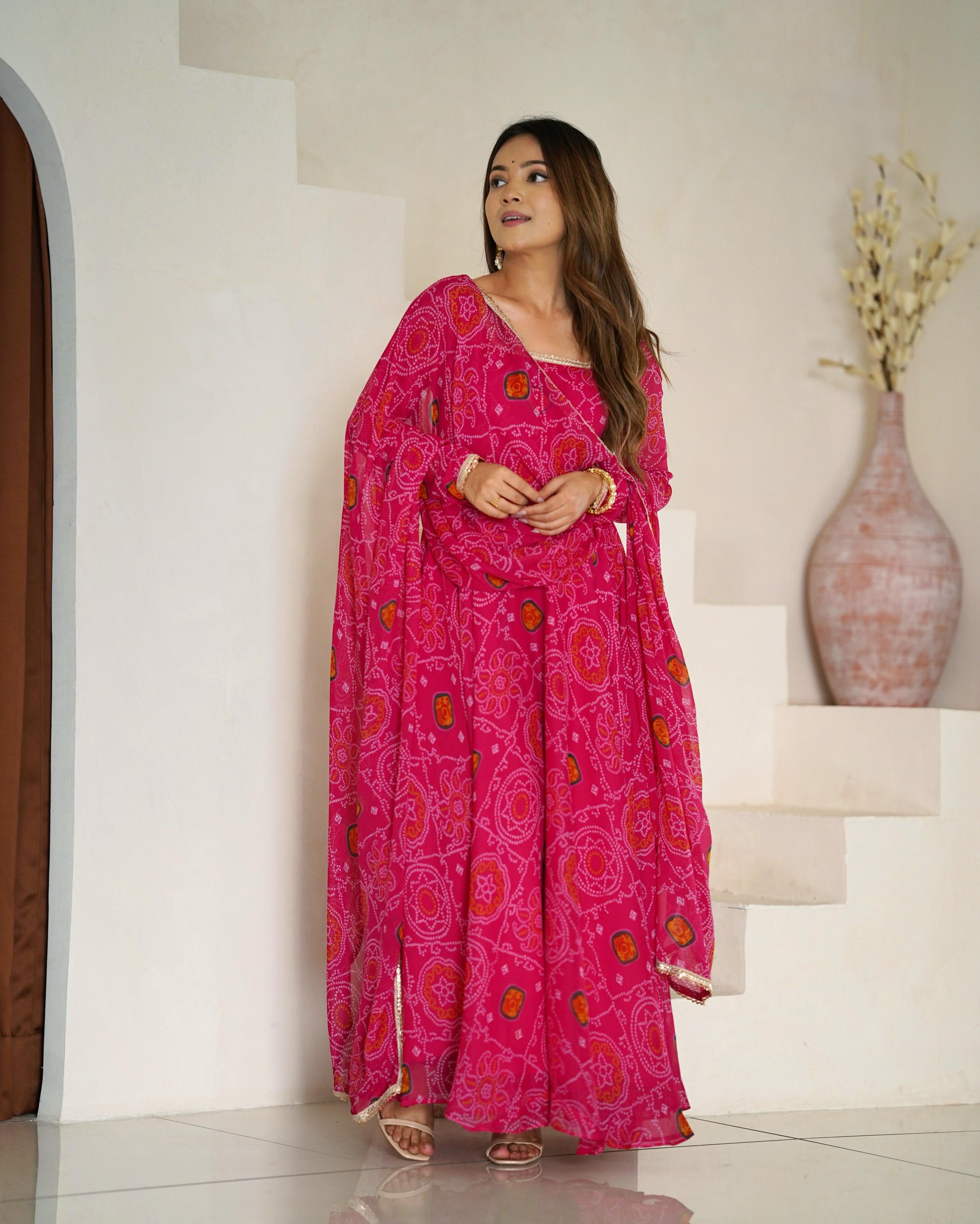 Pink color chiffon bandhej long gown for party