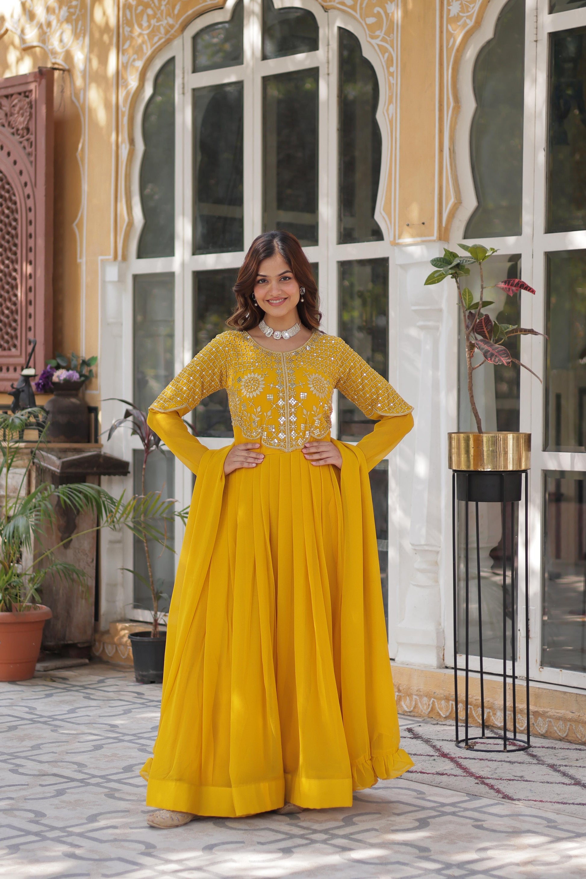 Demanding Yellow Color Faux Blooming Designer Gown For Engagement