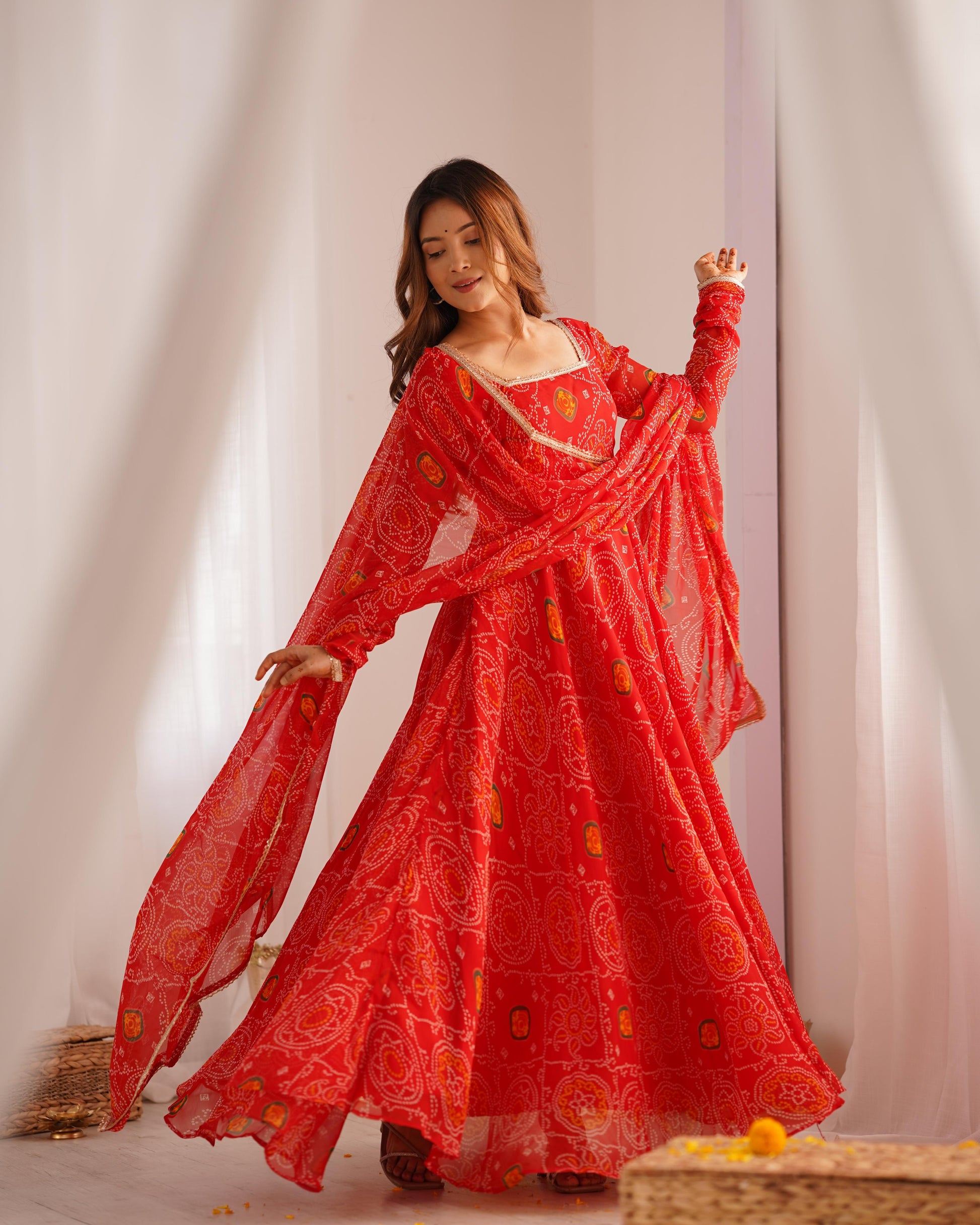 Red color chiffon bandhej long gown for festive